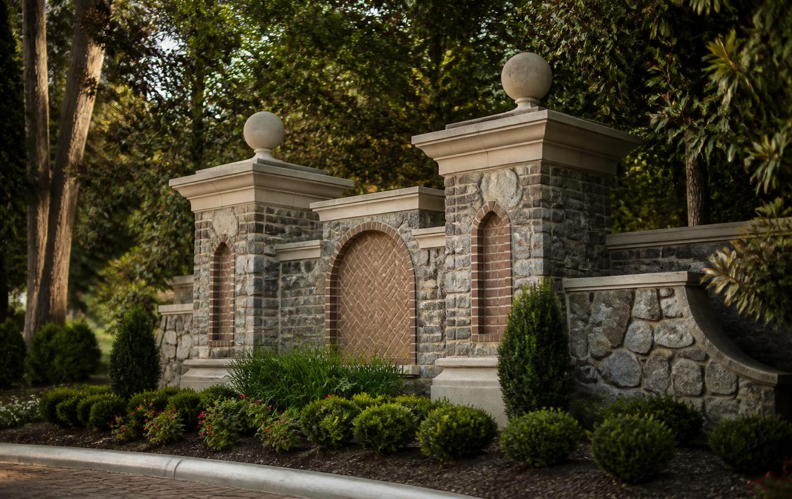 A stone and brick neighborhood entrance monument in the Quail Hollow area of Charlotte